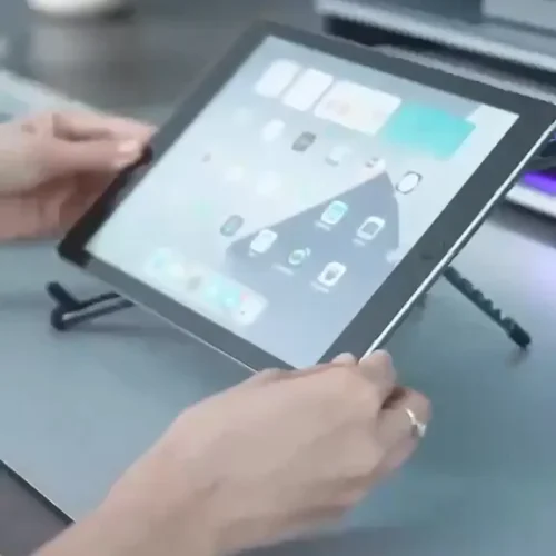 Foldable stand holding a tablet on a desk