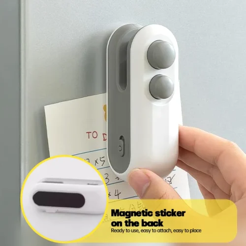 Mini bag sealer with magnet on the back stuck to the fridge