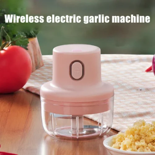 Electric garlic chopper next to finely chopped garlic