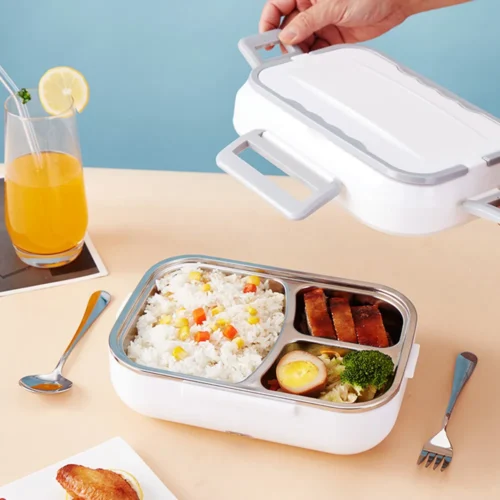 Electric lunch box with steel tray of rice and food