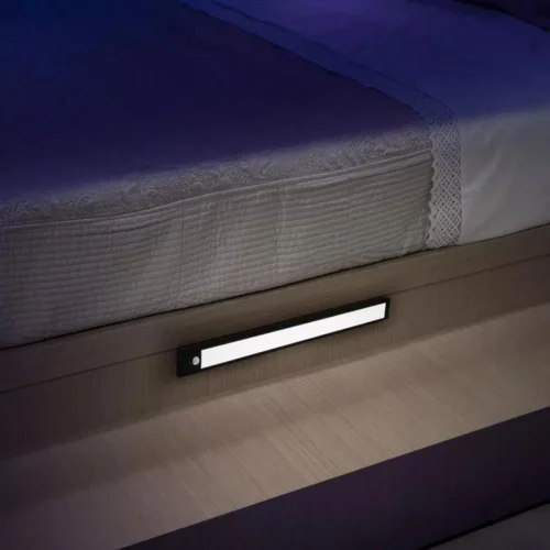 Motion sensor LED light bar under a bed at night