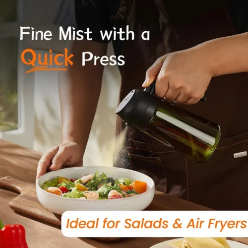 Oil sprayer bottle spraying a fine mist over a salad